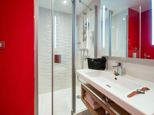 圣马洛圣马洛港宜必思尚品酒店的一间带水槽和玻璃淋浴的浴室