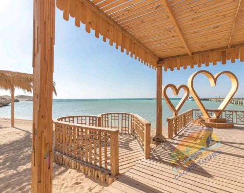 赫尔格达Dolphin house的海滩上带两个心脏的木甲板