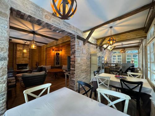 波罗维茨Villa Rila Borovets Mountain & Luxury with Hot Jacuzzi & Sauna的一间设有白色桌椅的用餐室