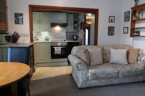 鲍内斯温德米尔Cosy 2-bedroom cottage in the Lake District的带沙发的客厅和厨房