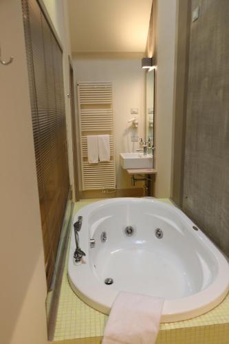 科尔特弗兰卡博尔格桑塔朱莉亚酒店的一个带水槽的浴室内的白色大浴缸