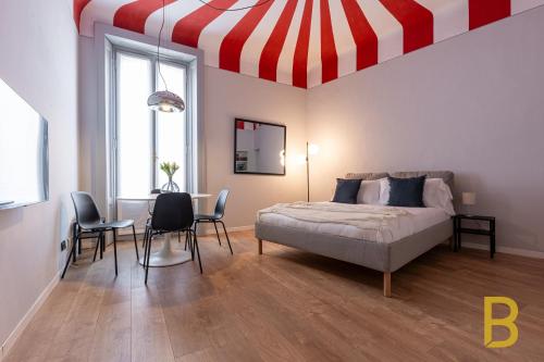 米兰BePlace Apartments in Chinatown的一间卧室设有一张床,拥有红色和白色的天花板