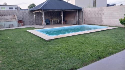 胡宁Casa con pileta Matheu的后院,草地上设有游泳池