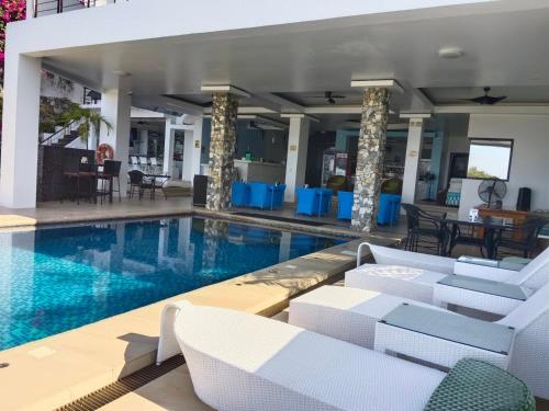 波尔多·格尼拉马娜拉海景度假酒店的一个带白色椅子和桌子的游泳池