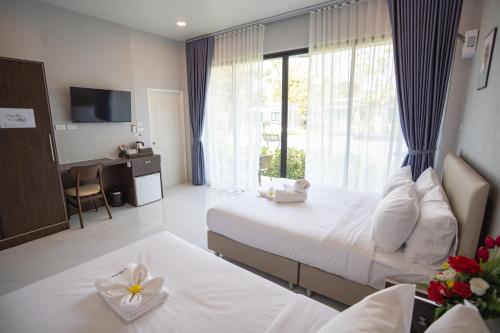 Ban Pak NamSeeView Resort (ซีวิว รีสอร์ต)的酒店客房设有两张床和窗户。