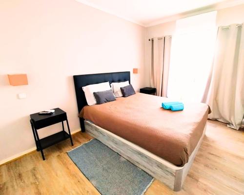 波尔蒂芒Appartement Praia da Rocha的一间卧室,配有一张蓝色的床