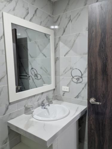 瓜亚基尔SUITES GARZOTA的白色的浴室设有水槽和镜子