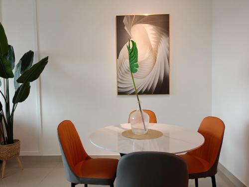 芙蓉Bayu Temiang Luxury Design 7~8 Pax的一张带椅子的白色桌子和一个花瓶