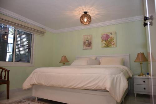 麦地那منتجع ريف خزيمة - الصباح的一间卧室配有一张带白色床单的大床