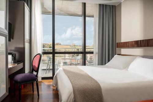 圣马力诺Welcome Hotel的酒店客房设有一张床和一个大窗户