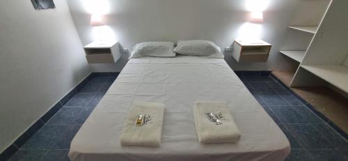 拉里奥哈COMPLEJO TURISTICO RIOJA的房间里的一张床位,上面有两条毛巾