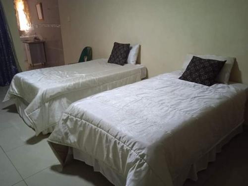 勒迪格Tsoga Odire BNB的两张睡床彼此相邻,位于一个房间里