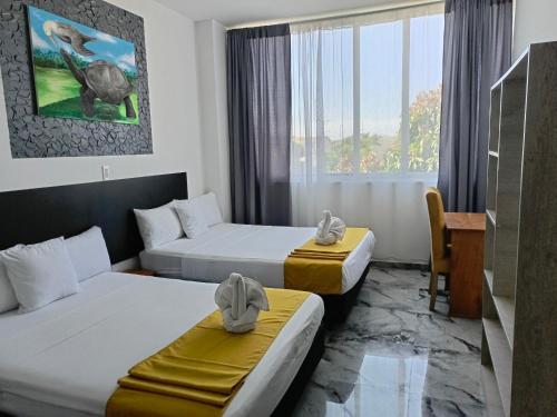 阿约拉港Patty House Galapagos的酒店客房配有两张床和一张书桌