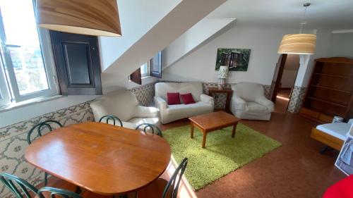 克卢什Apartamentos Turisticos Queluz的客厅配有桌子和沙发