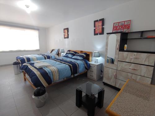 瓦拉斯Amplias y Centricas Habitaciones Huaraz WIFI, AGUA CALIENTE的一间卧室配有一张床和一个梳妆台