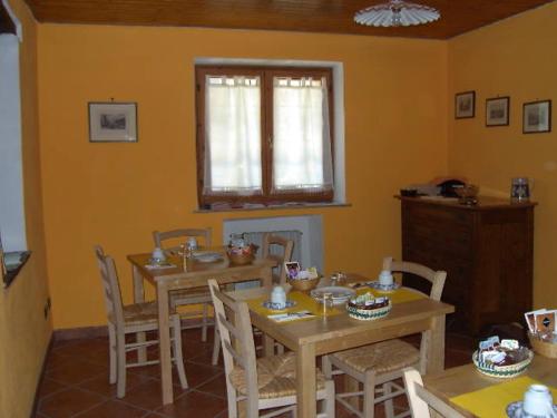 普拉吉拉托IL达悟住宿加早餐旅馆的一间带桌椅的用餐室和窗户。
