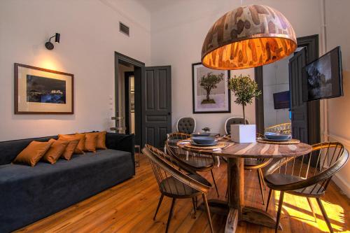 雅典Art Pantheon - Suites & Apartments的客厅配有桌子和沙发