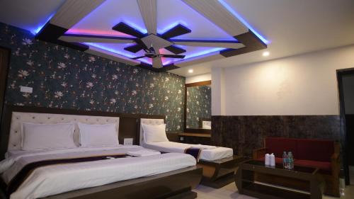 迪卡Ananya Hotel的一间卧室配有两张床和吊扇