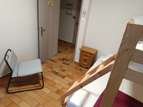 莱德萨阿尔卑斯La Mansio de Bons的一间卧室配有双层床和椅子