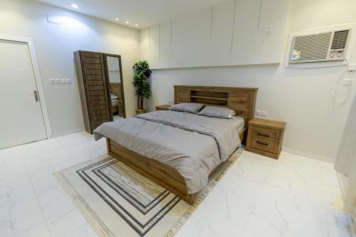 Al Harazatشاليهات الجوري的一间卧室配有一张大床和镜子