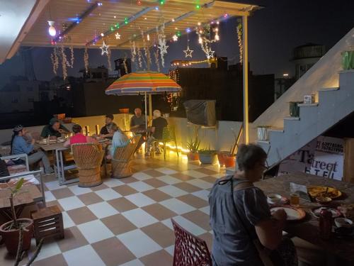 阿格拉Taj Street Hostel的一群坐在餐厅桌子上的人