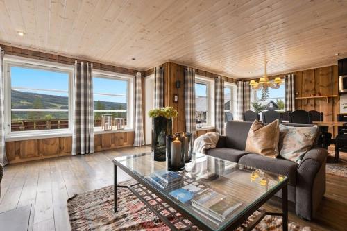 高尔Cozy cabin with sauna, ski tracks and golf outside的客厅配有沙发和桌子