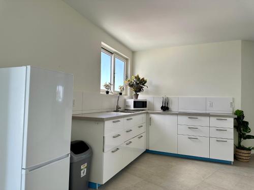 威廉斯塔德MERAKII SEAVIEW ESCAPE CURACAO的白色的厨房配有冰箱和窗户。
