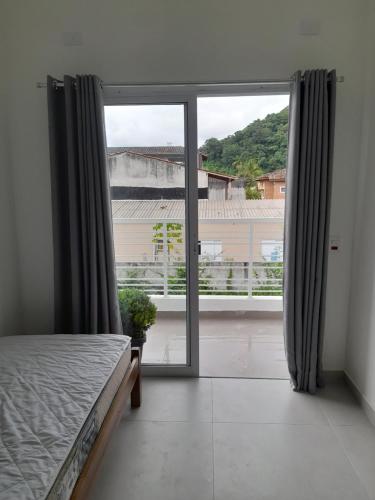 乌巴图巴Moriá Flats的一间卧室设有一张床和一个大窗户