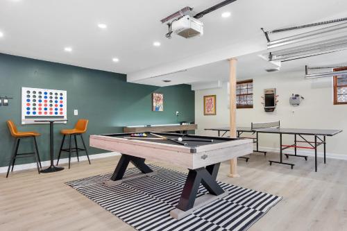 GansevoortGame Room+Hot Tub+Pool+King Beds+More的配有两张桌子和椅子的房间里一张乒乓球桌
