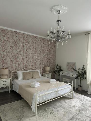 斯普利特Rooms Zana的白色卧室配有一张床和一个吊灯