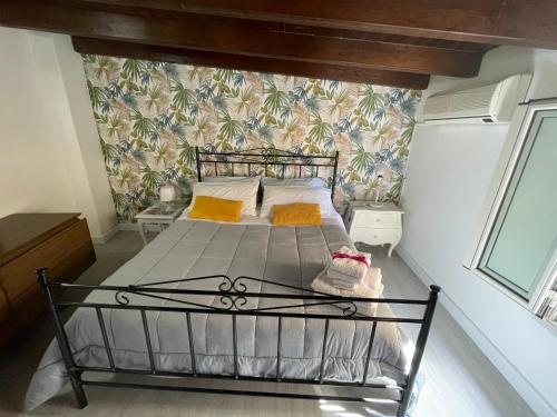巴勒莫La Zisa Holiday的卧室配有一张床铺,位于带墙壁的房间