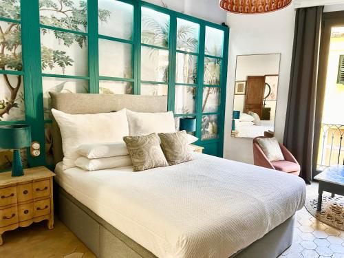 马略卡岛帕尔马Dog Admiral - Urban Guest House的一间卧室配有一张大床和蓝色床头板