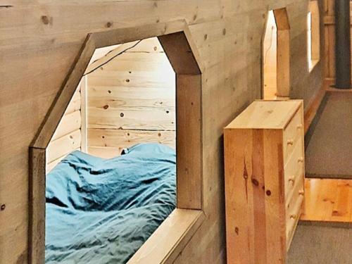 BureåHoliday home Bureå的一张位于带镜子的木制房间内的床铺
