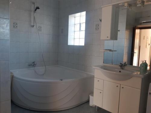 普拉Apartment Marija的白色的浴室设有浴缸和水槽。