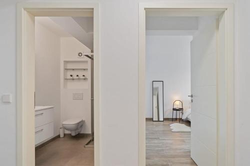 卢森堡Tranquil Haven - Relax and Unwind in Hamm ID23的白色的浴室设有卫生间和水槽。