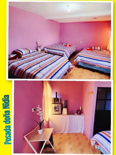 克萨尔特南戈Posada doña Nidia的配有粉红色和紫色墙壁的客房内的两张床