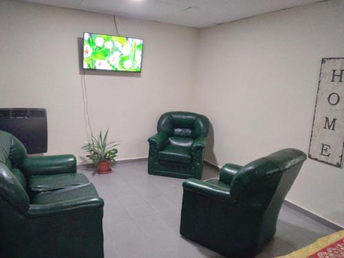Puerto Santa CruzAlojamiento laura的一间设有两把椅子和电视的等候室