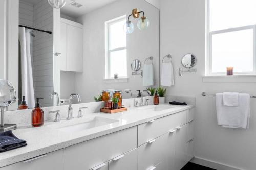 奥斯汀Insta-worthy - 6BR Home Rainey Street - 6 min walk的白色的浴室设有水槽和镜子