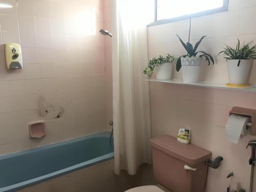 武吉丁宜Bukit Tinggi Fuchsia Hillhomes的浴室设有卫生间和植物浴缸。
