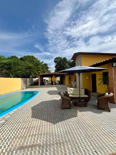 圣路易斯Espaço Prime SLZ的一个带游泳池、桌子和遮阳伞的庭院