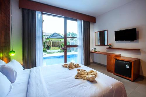 库塔普达科苏丽尤尼祖旅舍的酒店客房,配有带毛巾的床