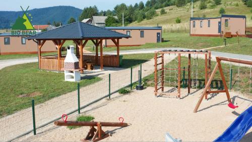 Donji Babin PotokBig Bear Plitvice Nature Resort的一个带秋千和凉亭的游乐场