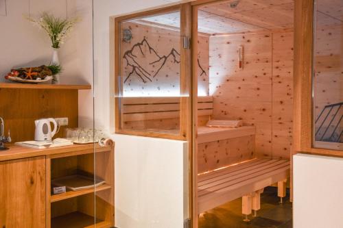 施勒肯Lisas - with Wellness and Breakfast的一间设有木墙和玻璃门的桑拿浴室