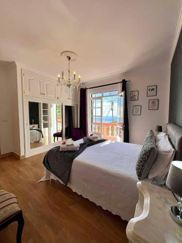 里韦拉布拉瓦Blue Paradise Apartment的一间卧室配有一张大床和一个吊灯。