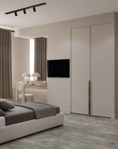 巴库Dastan Hotel Baku的一间卧室配有一张床,墙上配有电视
