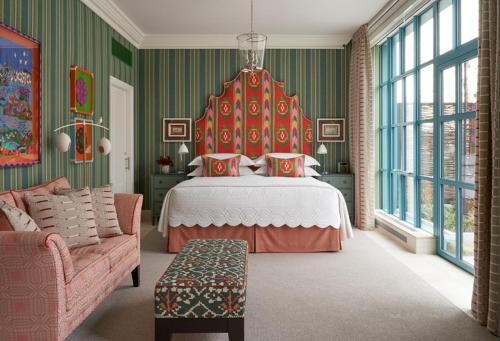 纽约Warren Street Hotel的一间卧室配有一张带红色床头板的床和一张沙发