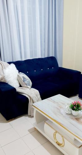RuiruAirbnb的客厅配有蓝色的沙发和桌子