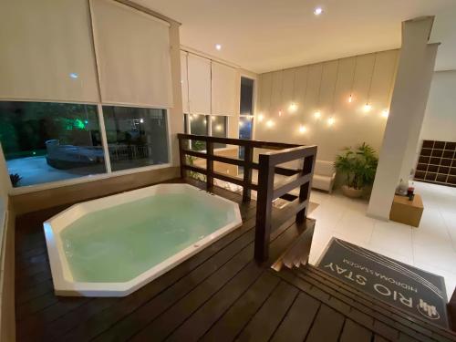 里约热内卢Suíte & Flat Premium Rio Stay - Rio Centro的木制甲板上的大型浴缸