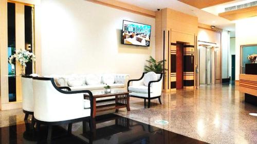 Ban Lam Rua TaekValaya Hotel Pathumthani的客厅配有沙发和桌椅
