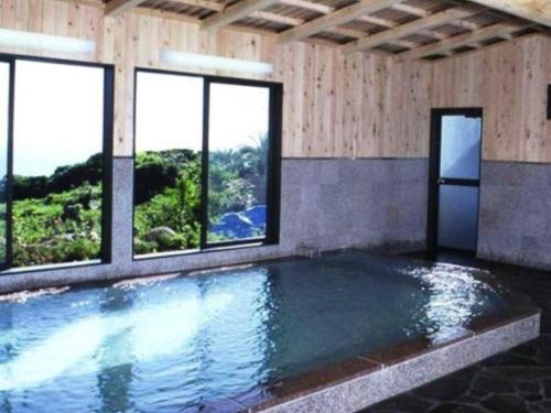 IsaAshizuri Onsen Ashizuri Sunnyside Hotel的窗户的房间内的游泳池